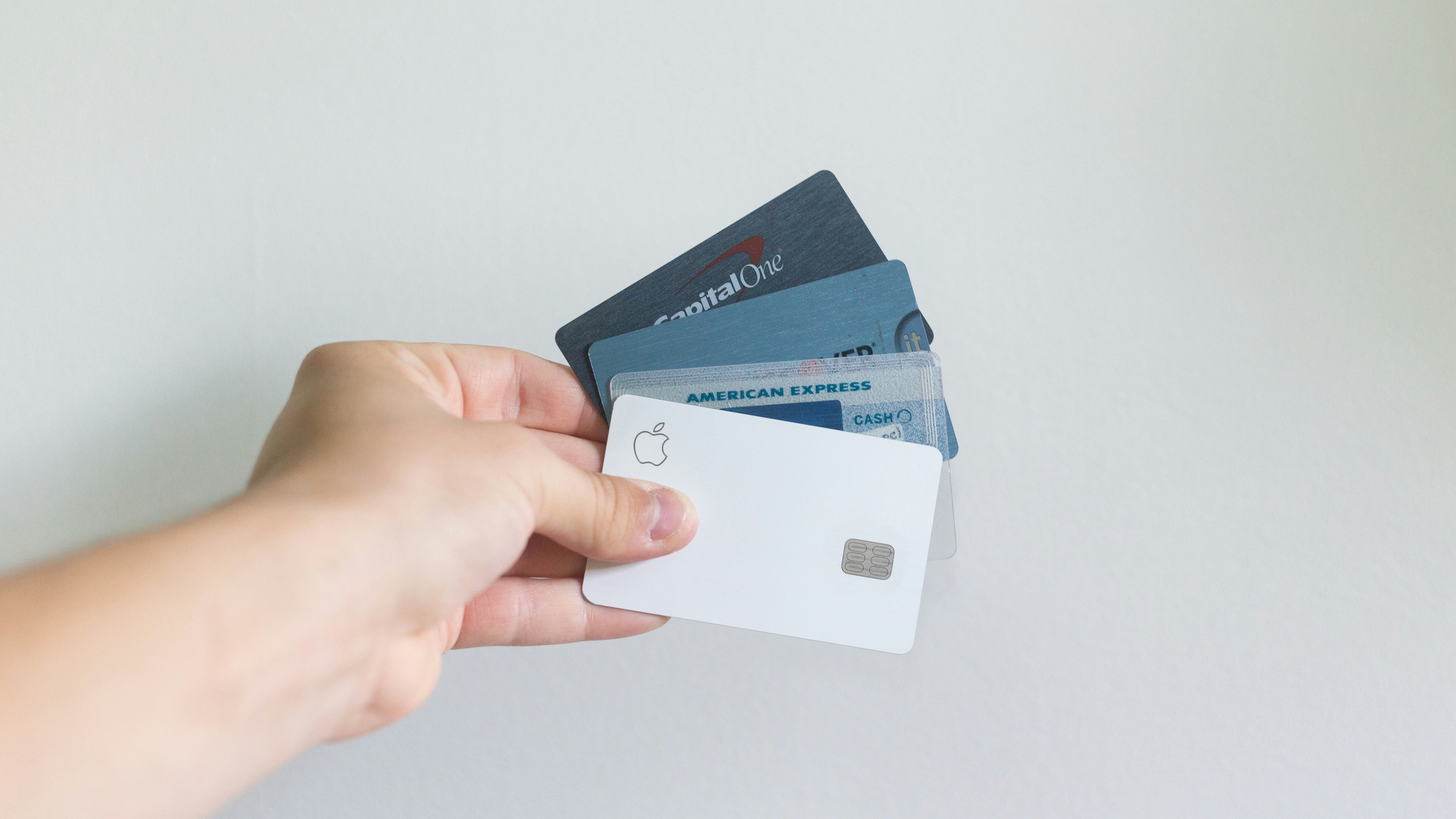 hand holding four credit cards