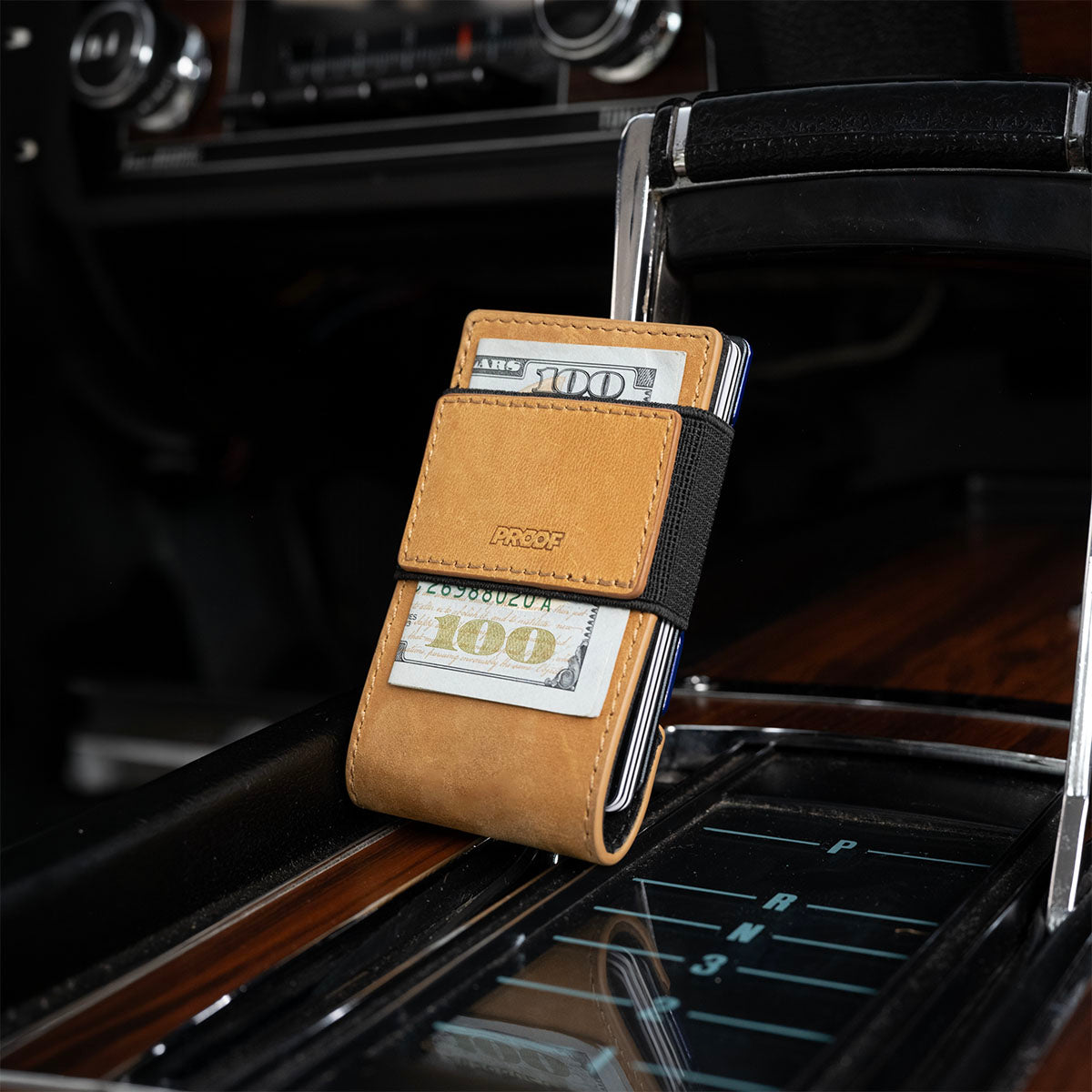 Back of the PROOF Octane wallet showing the Rally Blue striped plate, inside a 1969 Camaro Z10