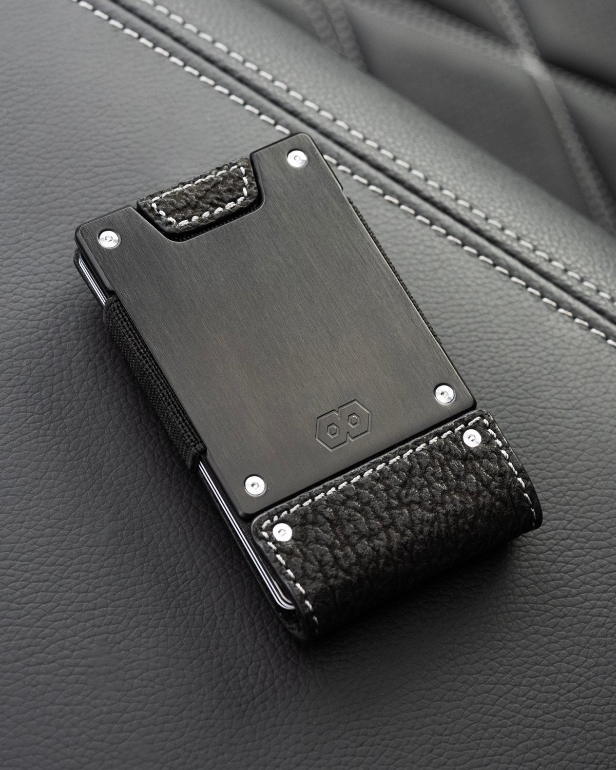 PROOF Blackwater minimalist wallet with shark leather resting on a black leather Ford F-250 seat