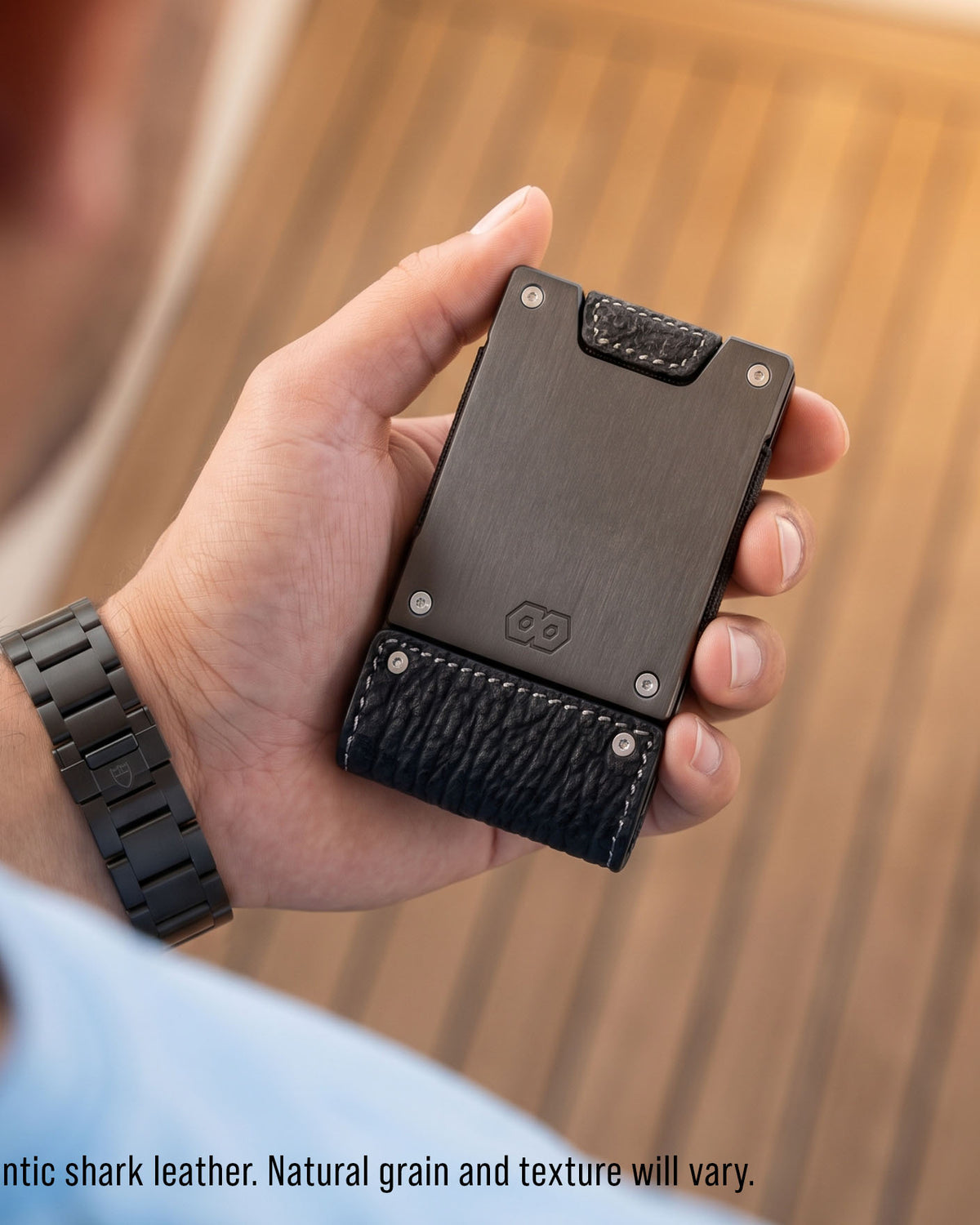 The Blackwater shark leather wallet held in hand on a yacht