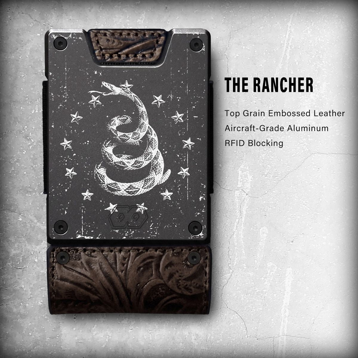 Wallet with a Gadsden rattlesnake engraving on a dark metal plate and tooled brown leather trim, labeled The Rancher.