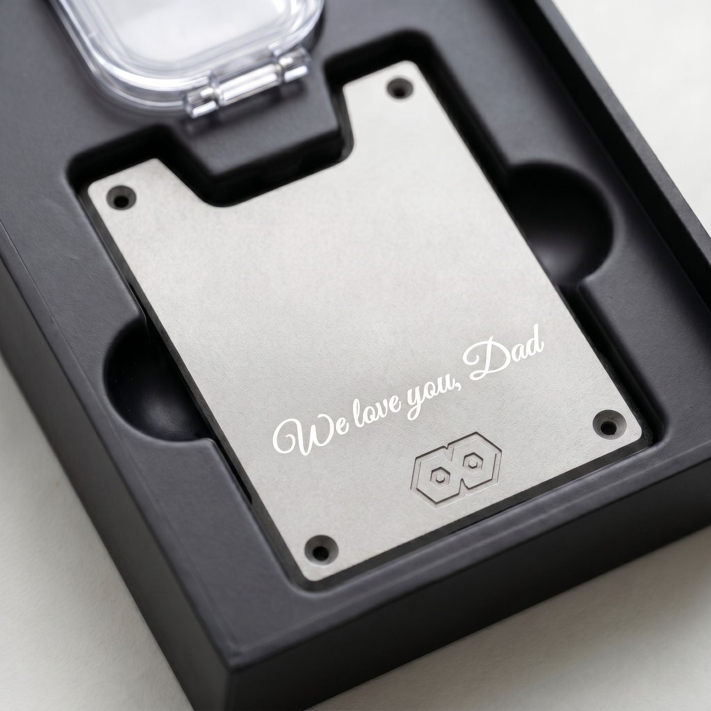 Wallet plate with 'We love you, Dad' engraving in a black box